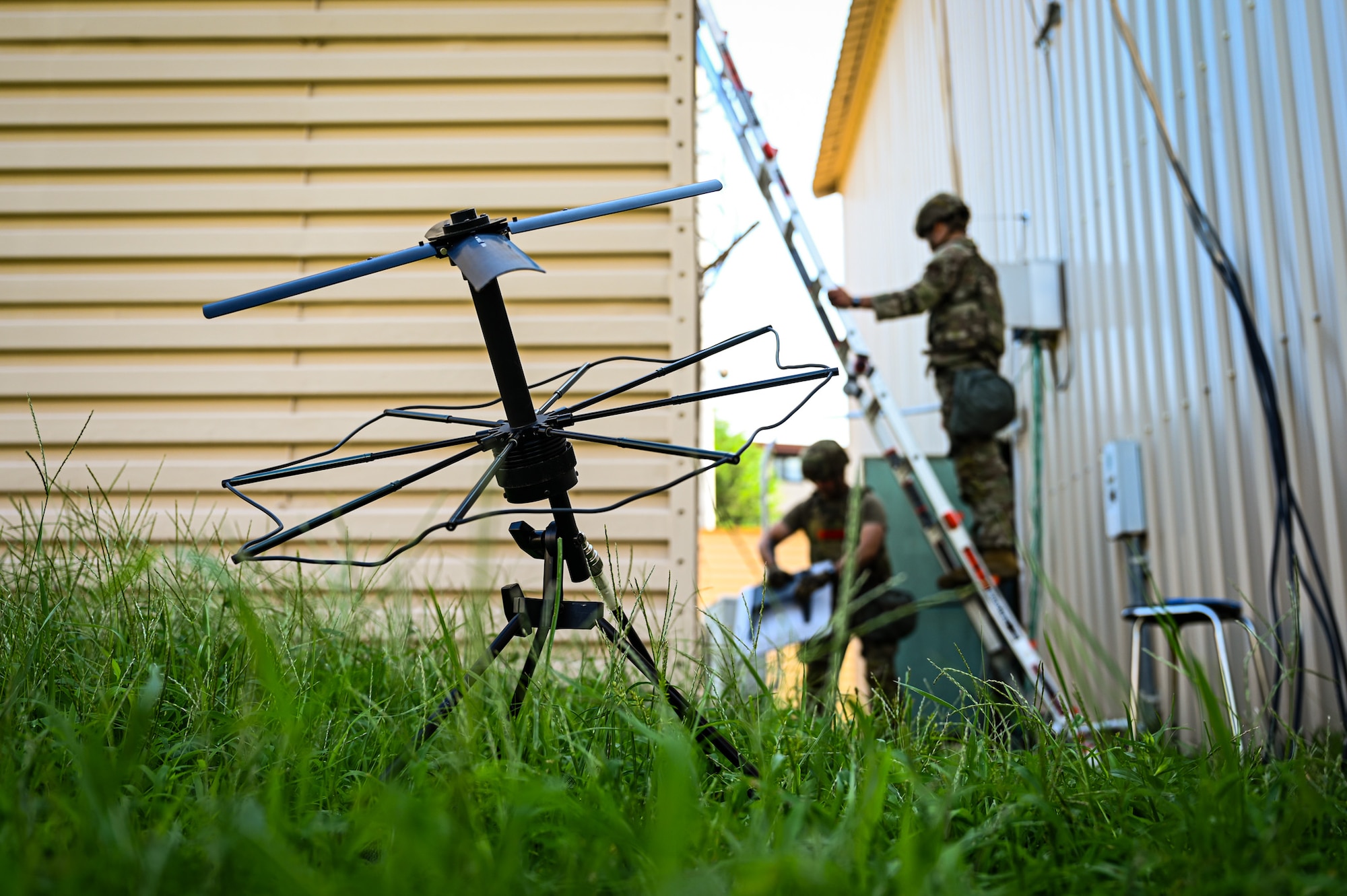 A small antenna sits in a field while U.S. Air Force Airmen from the 51st Combat Communications Squadron establish network capabilities at Daegu Air Base, Republic of Korea, Aug. 18, 2025. Part of the 461st Air Control Wing, the 51st CBCS operates out of Robins Air Force Base, Georgia, and is one of only four combat communications squadrons across the Air Force.