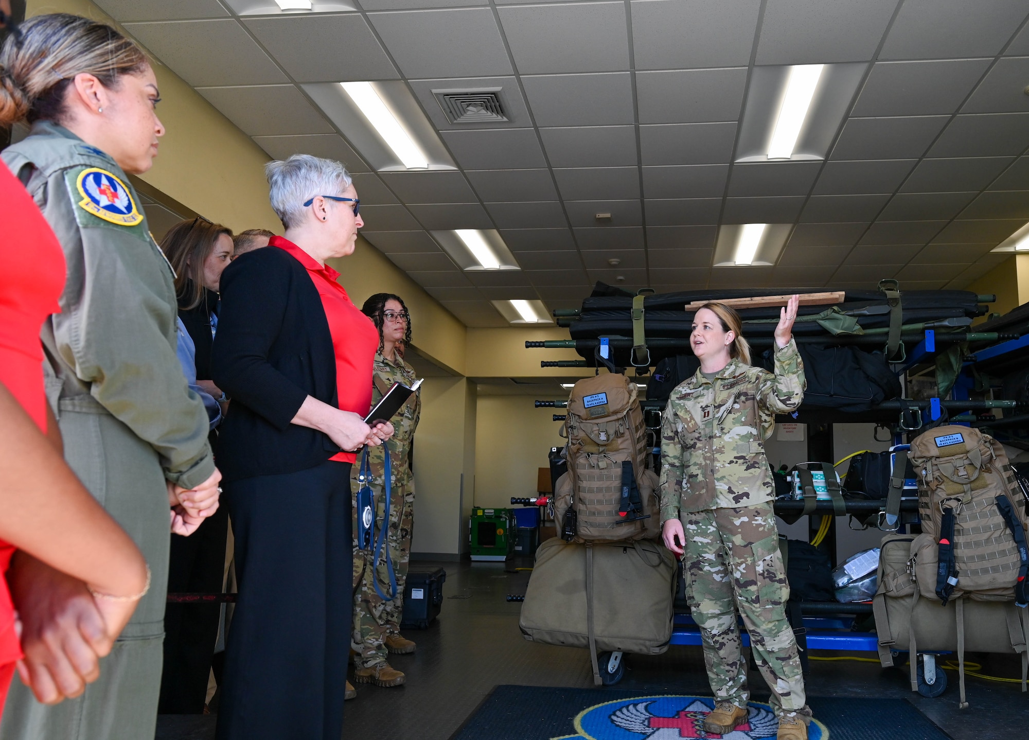 Service member show gear to civilians.