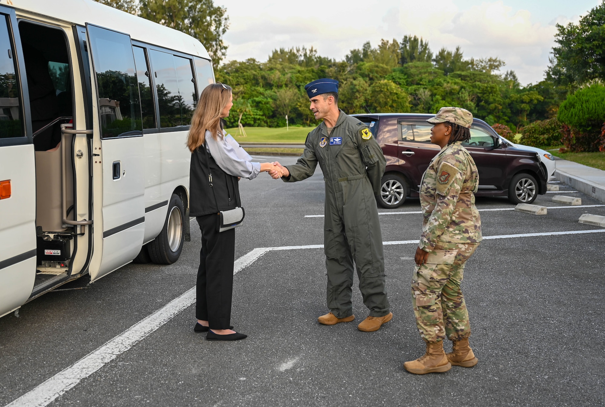 Service members greet civilian.