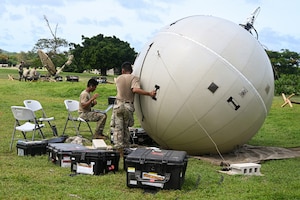 A U.S. Air Force Airman with the 51st Combat Communications Squadron sets up a ground antenna transmit and receive inflatable satellite to support the 11th Air Task Force in exercise Resolute Force Pacific in Saipan, Northern Mariana Islands, July 14, 2025. The 51st CBCS supported the 11th ATF throughout its deployment in the Pacific.