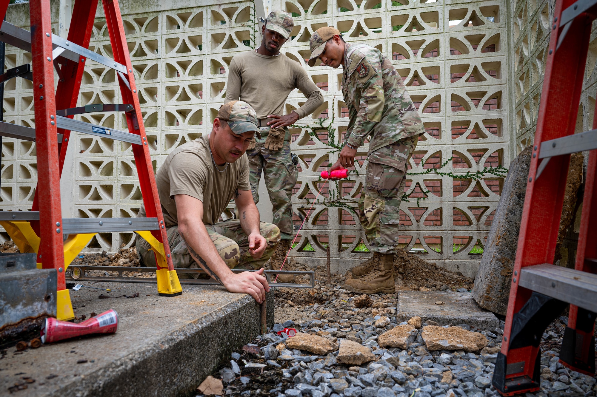 U.S. Air Force Airmen assigned to the 11th Combat Air Base Squadron, level the ground to install a concrete base at Kadena Air Base, Japan, Oct. 27, 2025.