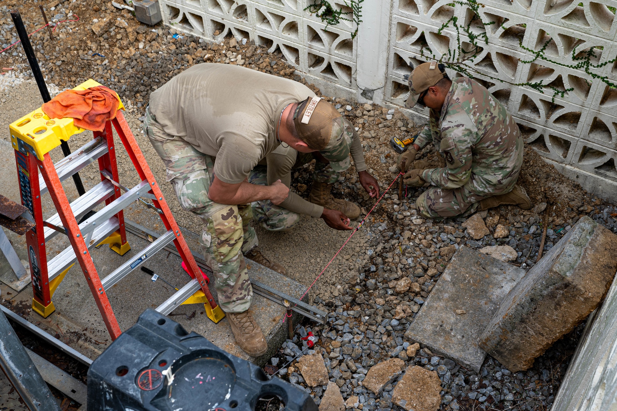 U.S. Air Force Airmen assigned to the 11th Combat Air Base Squadron, level the ground to install a concrete base at Kadena Air Base, Japan, Oct. 27, 2025.