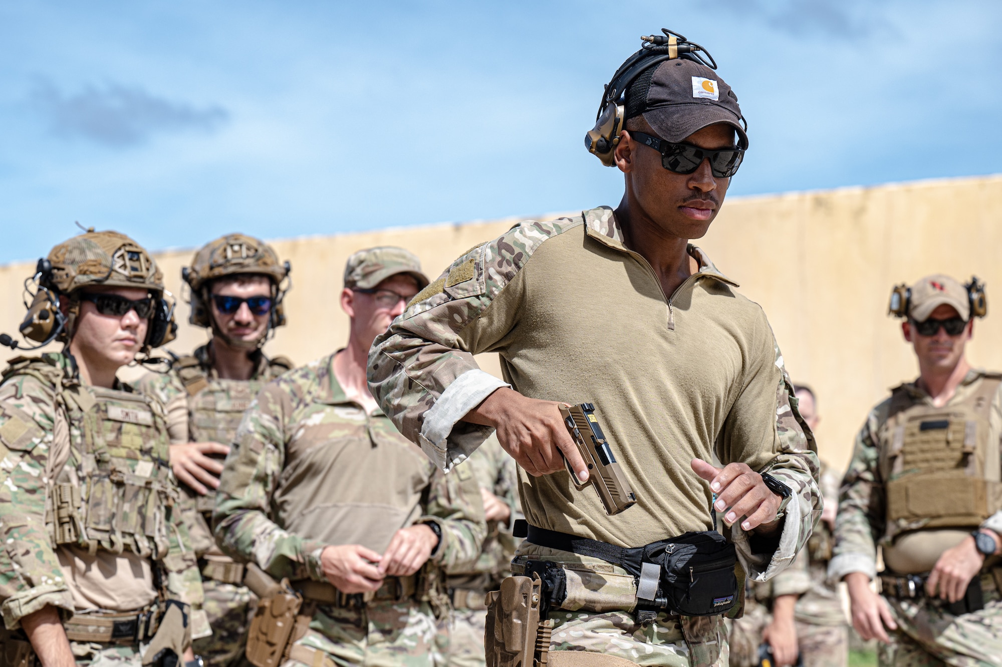 A U.S. Air Force Airman from the 824th Base Defense Squadron, holsters his Sig Sauer M18 handgun before his class begins the range live-fire at Andersen Air Force Base, Guam, Nov. 14, 2025.