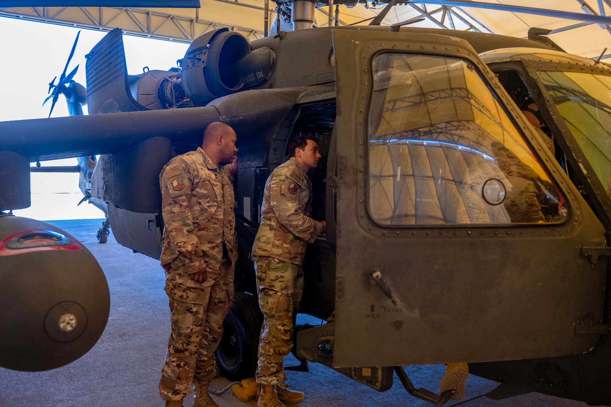 U.S. Airmen look inside a U.S. Army Black Hawk helicopter