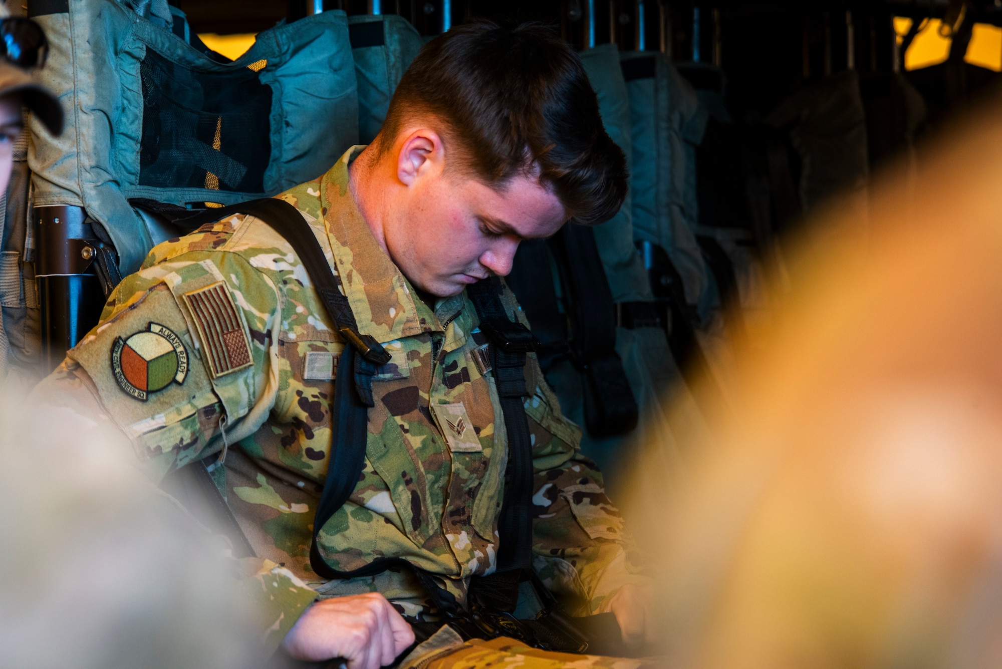 A U.S. service member fastens his harness