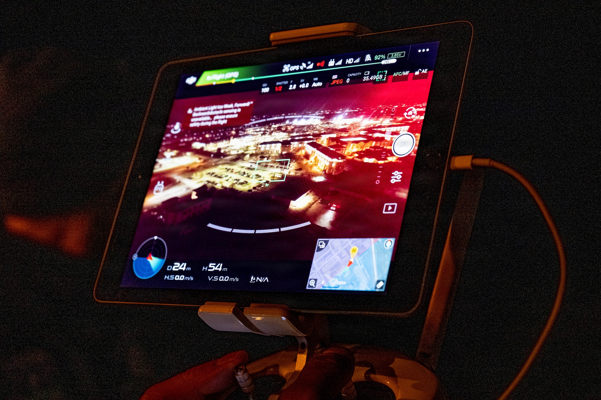 Drone view from the sky is displayed on a screen.