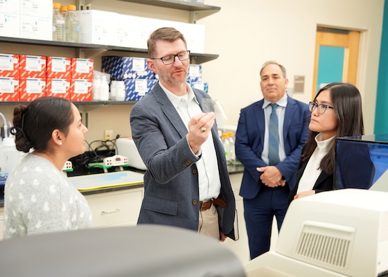 JOINT BASE SAN ANTONIO-FORT SAM HOUSTON (Dec. 8, 2025) Dr. Jeremy Pamplin, (center) program manager, Biological Technologies Office, Defense Advanced Research Projects Agency (DARPA), examines the method by which research scientists at Naval Medical Research Unit (NAMRU) San Antonio assess a wide range of inflammatory biomarkers in biological samples in support of DARPA’s Fieldable Solutions for Hemorrhage with bio-Artificial Resuscitation Products (FSHARP) program at the Battlefield Health & Trauma Research Institute. NAMRU San Antonio serves as the Independent Validation & Verification partner for the FSHARP program to perform laboratory testing for safety and efficacy. The FSHARP program works to develop a deployable, shelf-stable, universal whole blood substitute as a hemorrhage countermeasure to sustain injured warfighters in austere, pre-hospital settings. NAMRU San Antonio, part of Navy Medicine Research & Development, works alongside research partners in the civilian sphere, academia, industry, and other government agencies to drive support of the Department of War’s objectives for a lethal fighting force and ensures U.S. service members have access to the latest scientific advances. NAMRU San Antonio conducts gap-driven combat casualty care, craniofacial, and directed energy research in support of Navy, Marine Corps and joint U.S. warfighter health readiness and lethality while engaged in routine and expeditionary operations. (U.S. Navy photo by Burrell Parmer/Released)