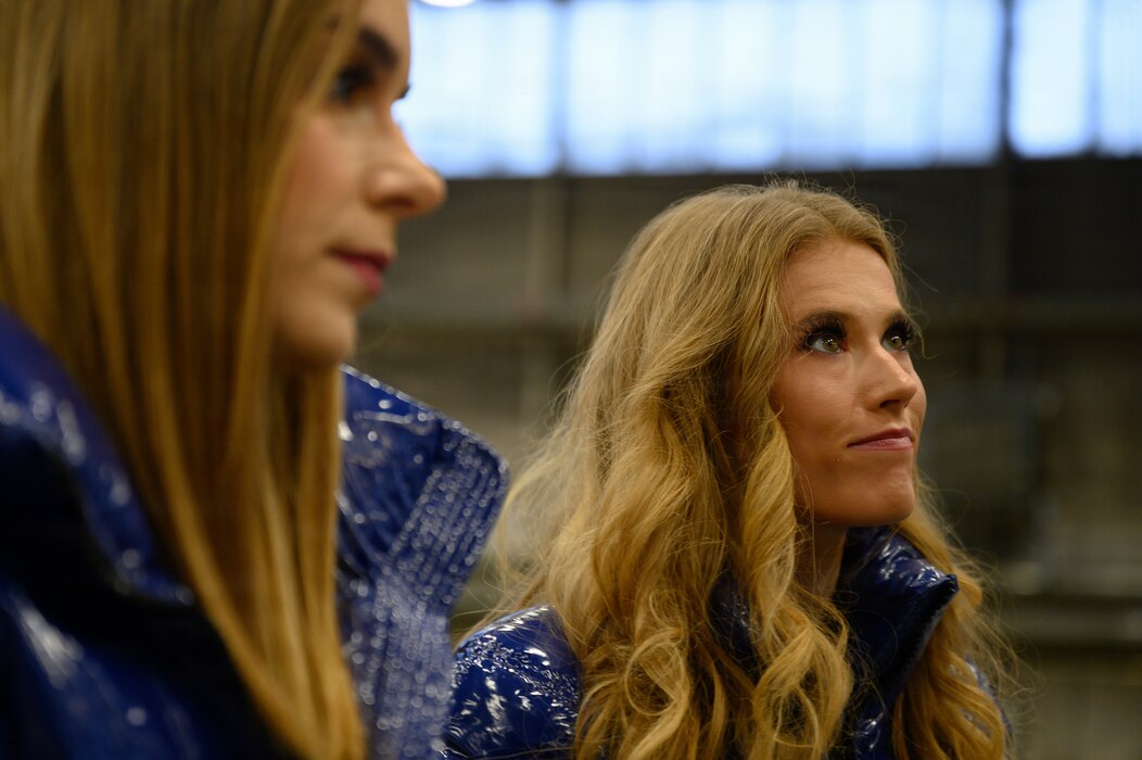 Two people look out to something outside the photo.