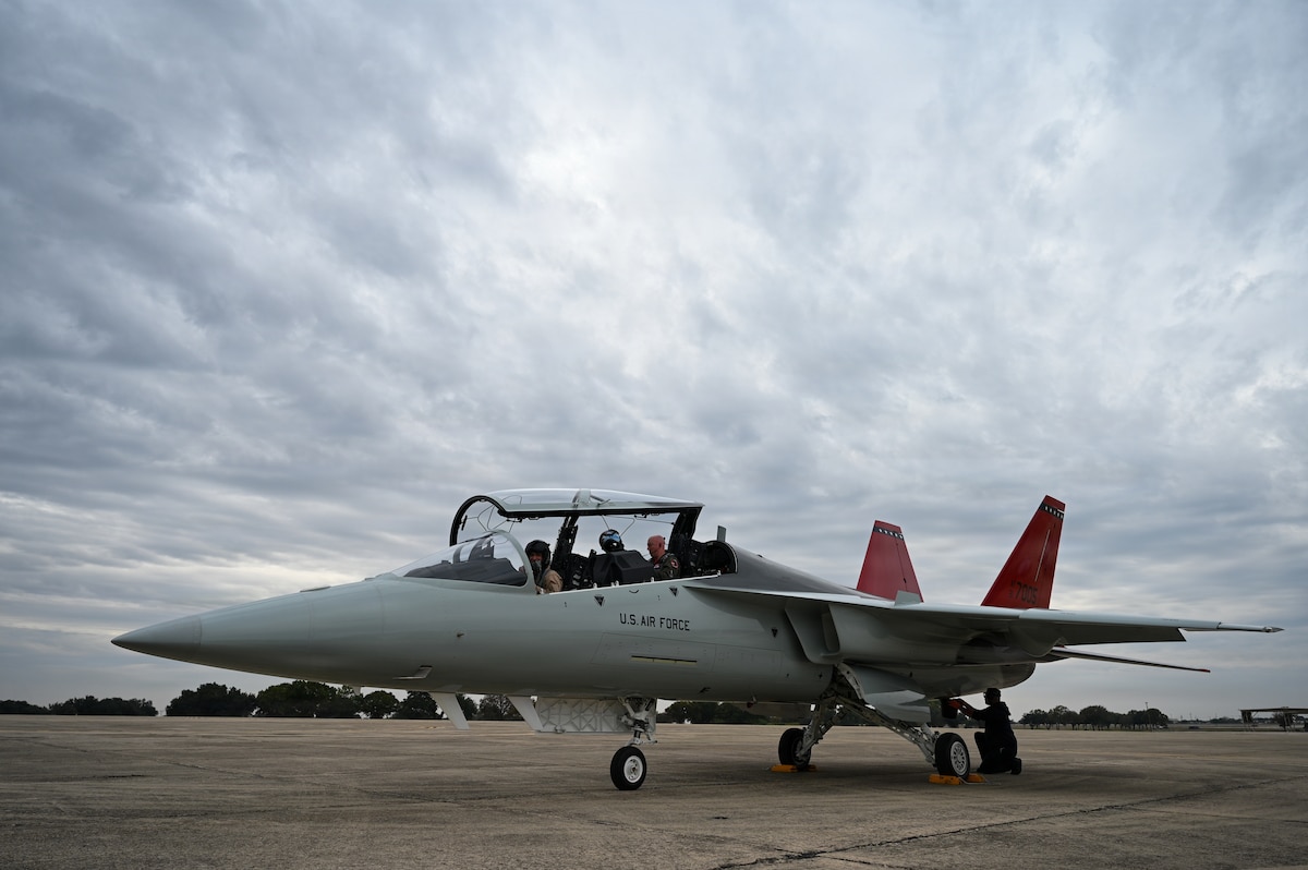 Lt. Col. Phillip Bourquin, 99th Flying Training Squadron director of operations, and Steve Schmidt, Boeing test pilot, prepare to disembark the T-7A Red Hawk after its historic arrival at Air Education Training Command at Joint Base San Antonio-Randolph, Texas, Dec. 5, 2025. The T-7A is the fleet’s newest training aircraft designed to train the next generation of pilots for 5th and 6th generation fighters. (U.S. Air Force photo by Tech. Sgt. Amy Winchell)