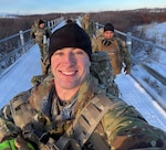 Alaska Army National Guard Spc. Brad Adams, assigned to the 297th Infantry Battalion’s Headquarters and Headquarters Company and his team ruck march into town after landing in Tuntutuliak, Nov. 13, 2025