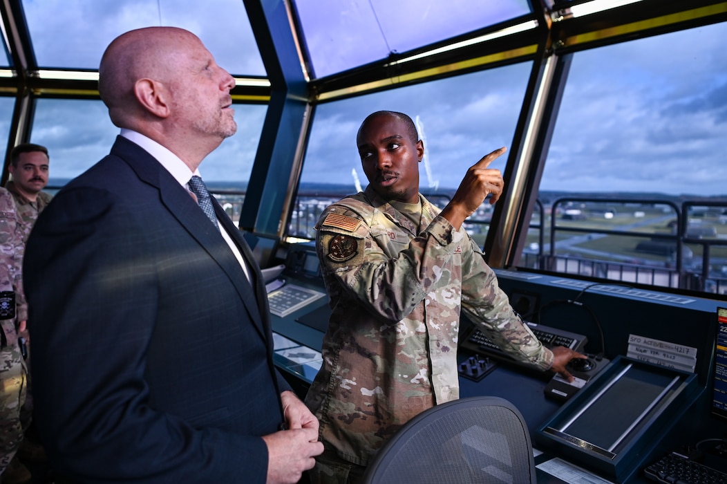 U.S. Air Force Tech. Sgt. Malcom Ford, 52nd Operations Support Squadron assistant chief tower controller, briefs Mr. Brian Heath, consul general at the U.S. Consulate General in Frankfurt, Germany, left, during an installation tour at Spangdahlem Air Base, Germany, Oct. 27, 2025.