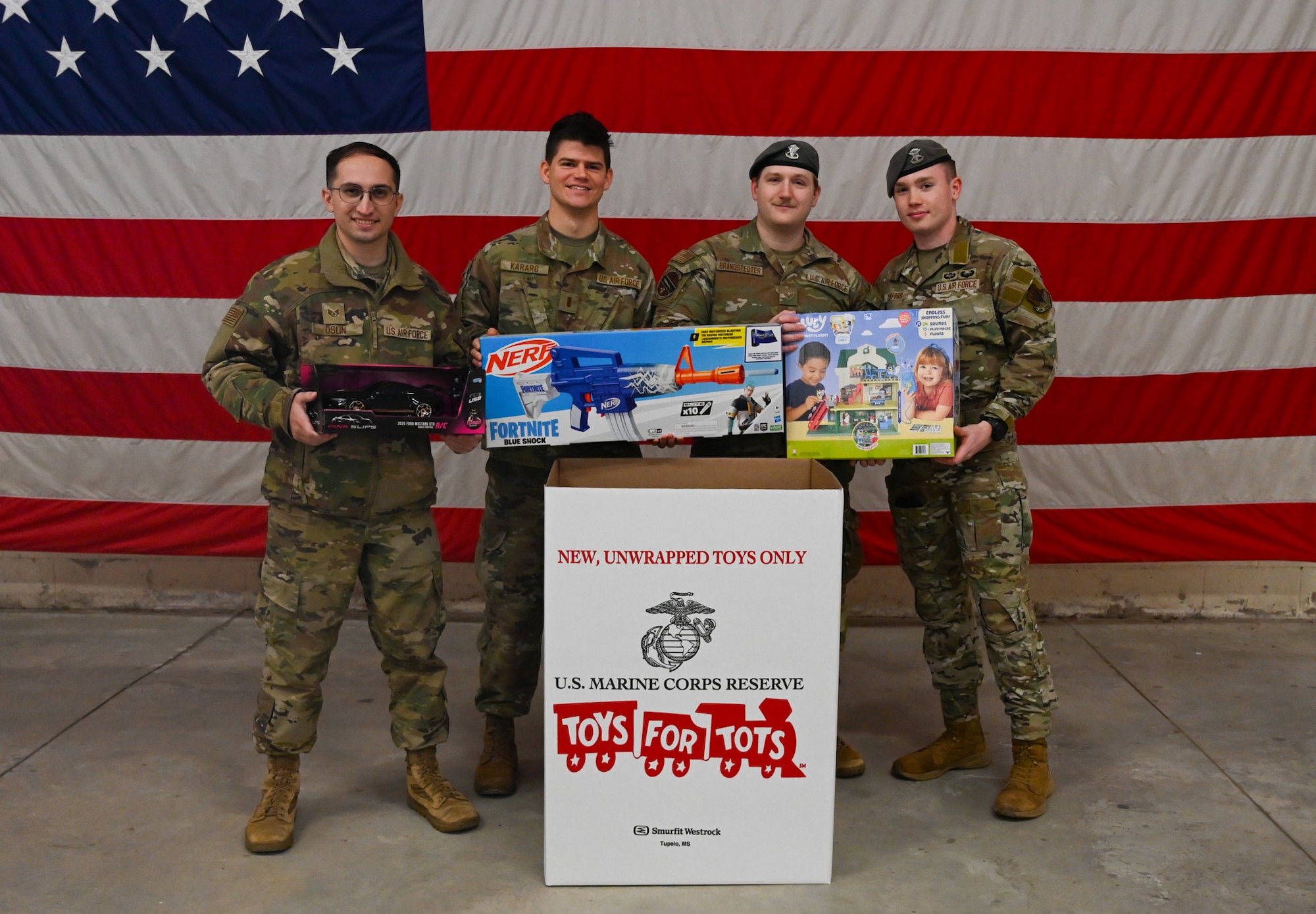 Four Airman hold toys