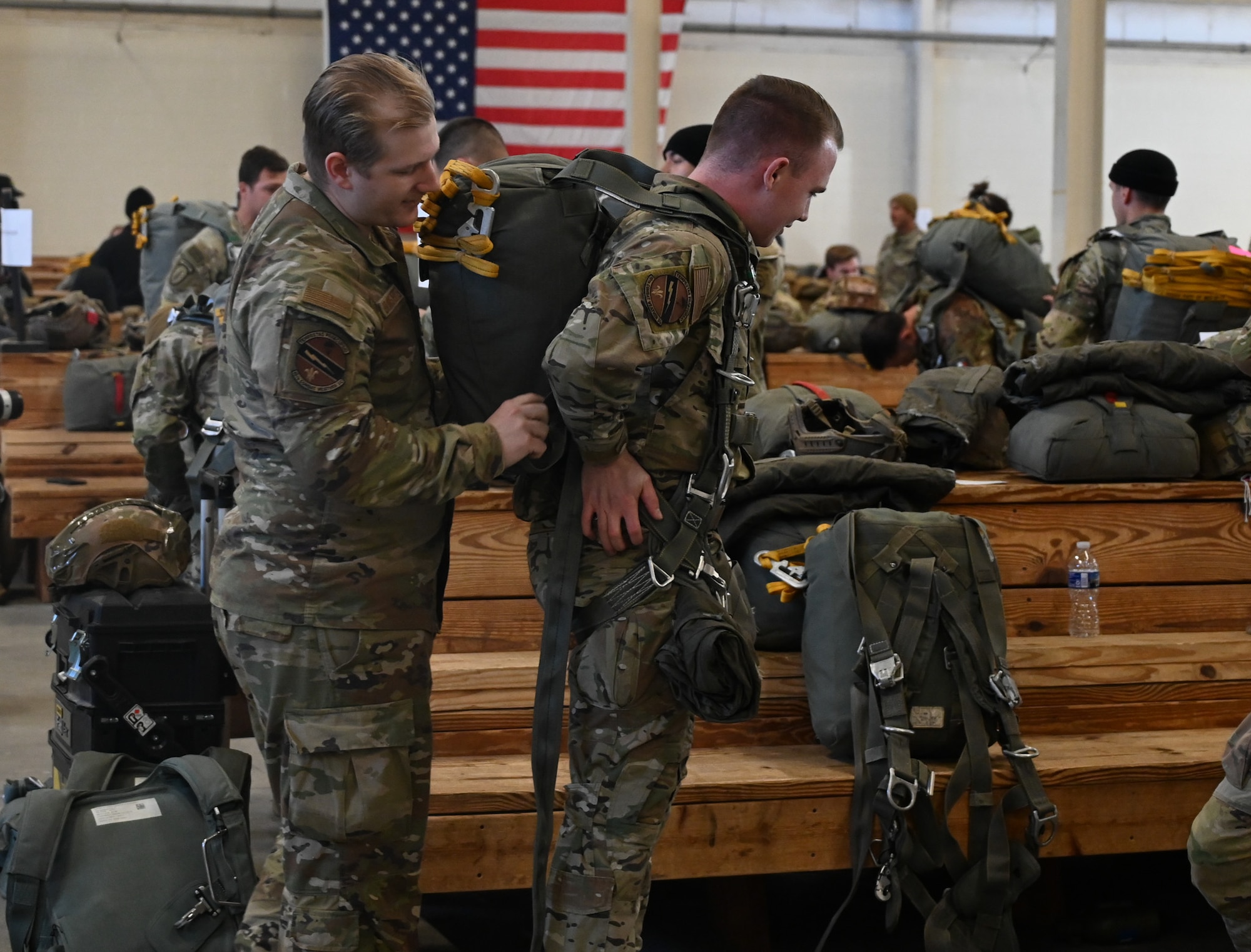 An Airman asset with donning a parachute.