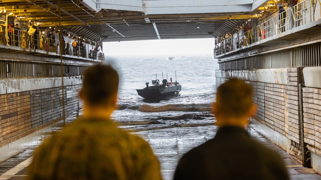 A U.S. Marine Corps amphibious combat vehicle with Alpha Company, 2nd Assault Amphibian Battalion, 2nd Marine Division re-embarks on the Whidbey Island-class dock landing ship USS Gunston Hall (LSD-44) during Naval Integration Training Package 2 off the coast of North Carolina, Dec. 5, 2025. NITP-2 is an amphibious, ship-to-shore, part of a larger training evolution certifying amphibious combat vehicle crewmen to safely and properly conduct combat operations with the ACV. (U.S. Marine Corps photo by Lance Cpl. Dominic Trujillo)