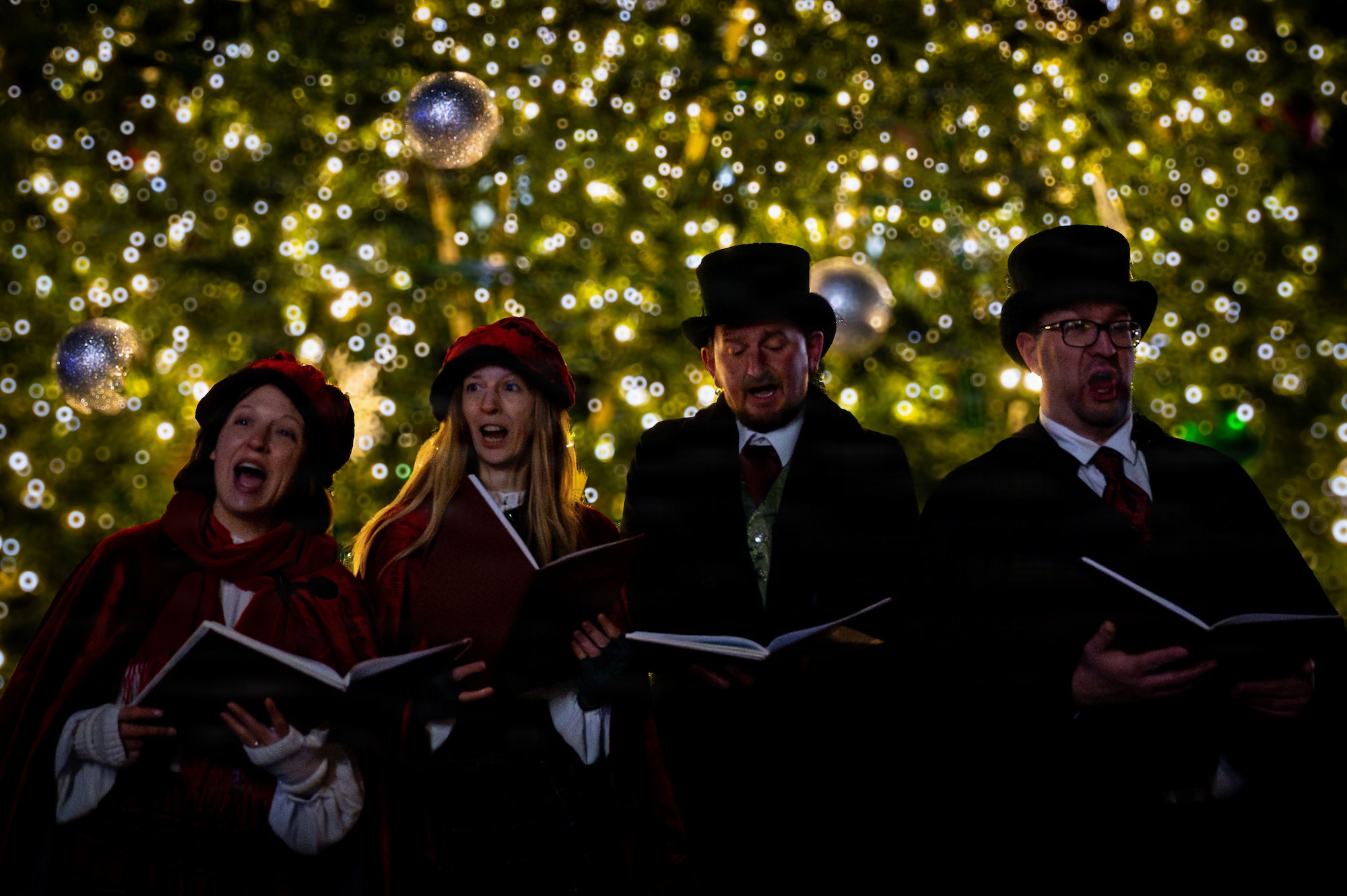 Victorian carolers sing during the holiday tree lighting ceremony at RAF Mildenhall, England, Dec. 5, 2025.