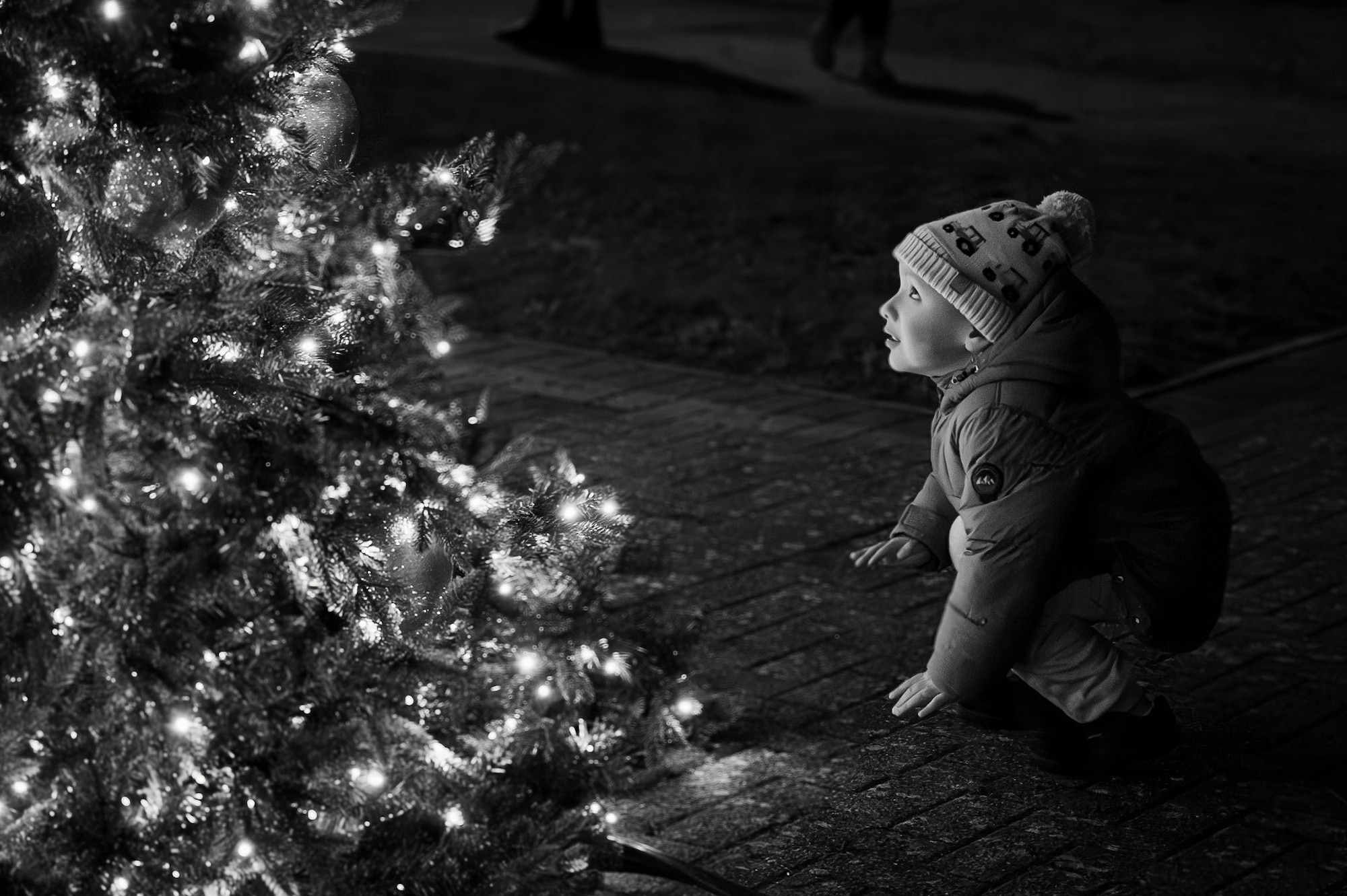 A child admires lights during the holiday tree lighting ceremony at RAF Mildenhall, England, Dec. 5, 2025.