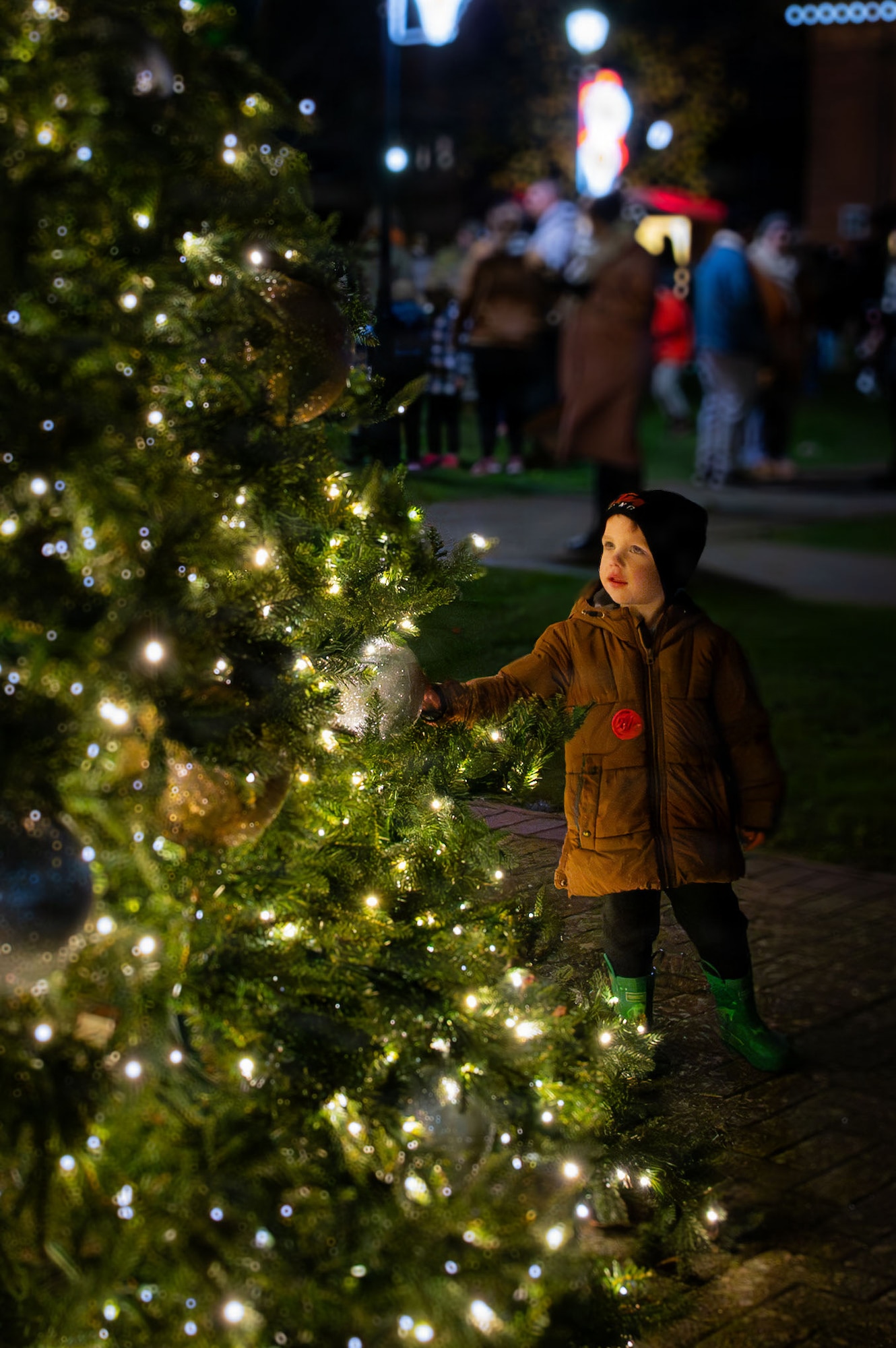 A child touches an ornament during the holiday tree lighting ceremony at RAF Mildenhall, England, Dec. 5, 2025.