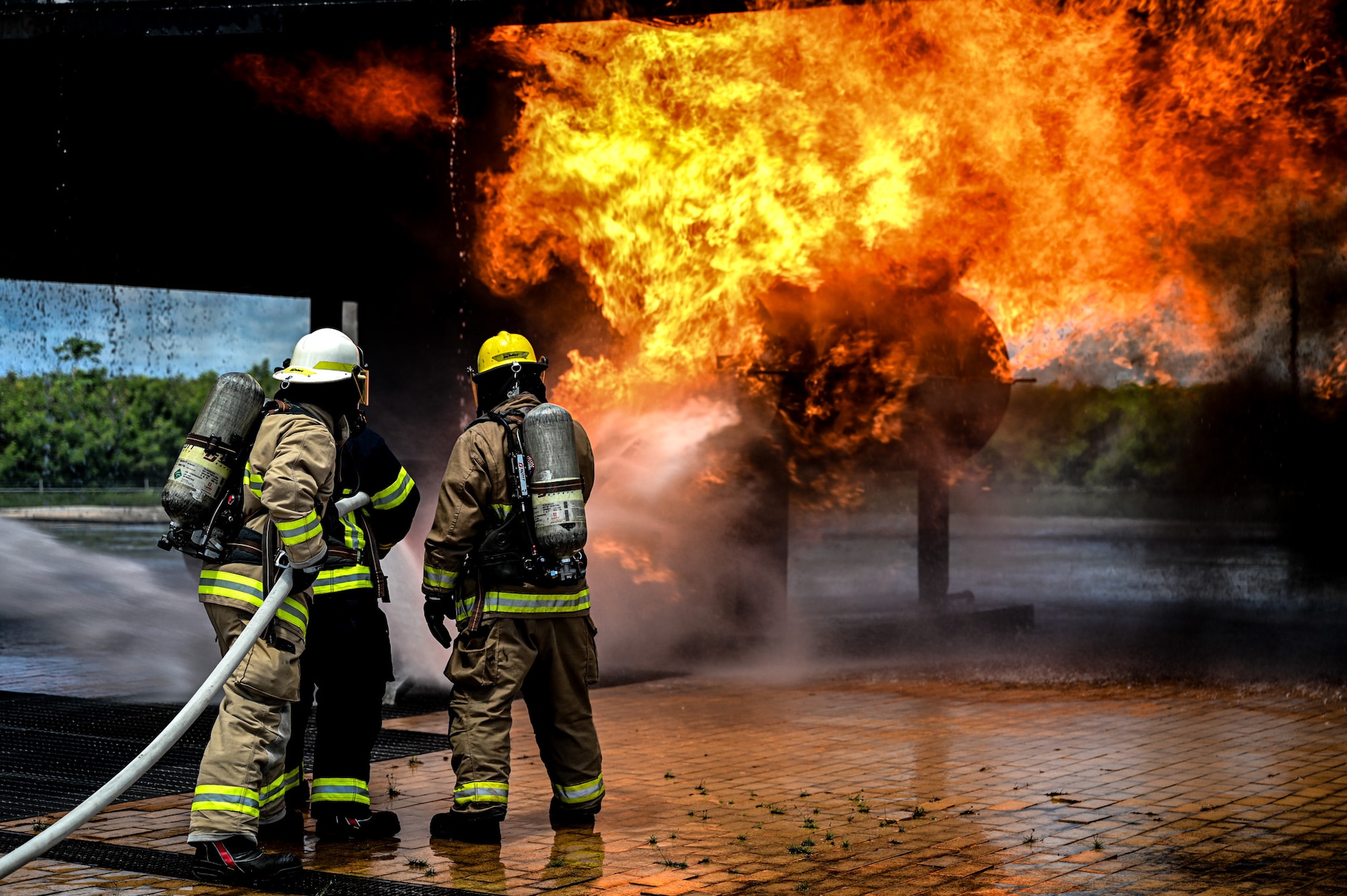 A firefighting instructor firefighter from the Saipan International Airport Aircraft Rescue and Firefighting Department trains U.S. Air Force Airmen from the 11th Combat Air Base Squadron on simulated aircraft fires during exercise Resolute Force Pacific in Saipan, Northern Mariana Islands, July 17, 2025.