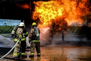 A firefighting instructor firefighter from the Saipan International Airport Aircraft Rescue and Firefighting Department trains U.S. Air Force Airmen from the 11th Combat Air Base Squadron on simulated aircraft fires during exercise Resolute Force Pacific in Saipan, Northern Mariana Islands, July 17, 2025.