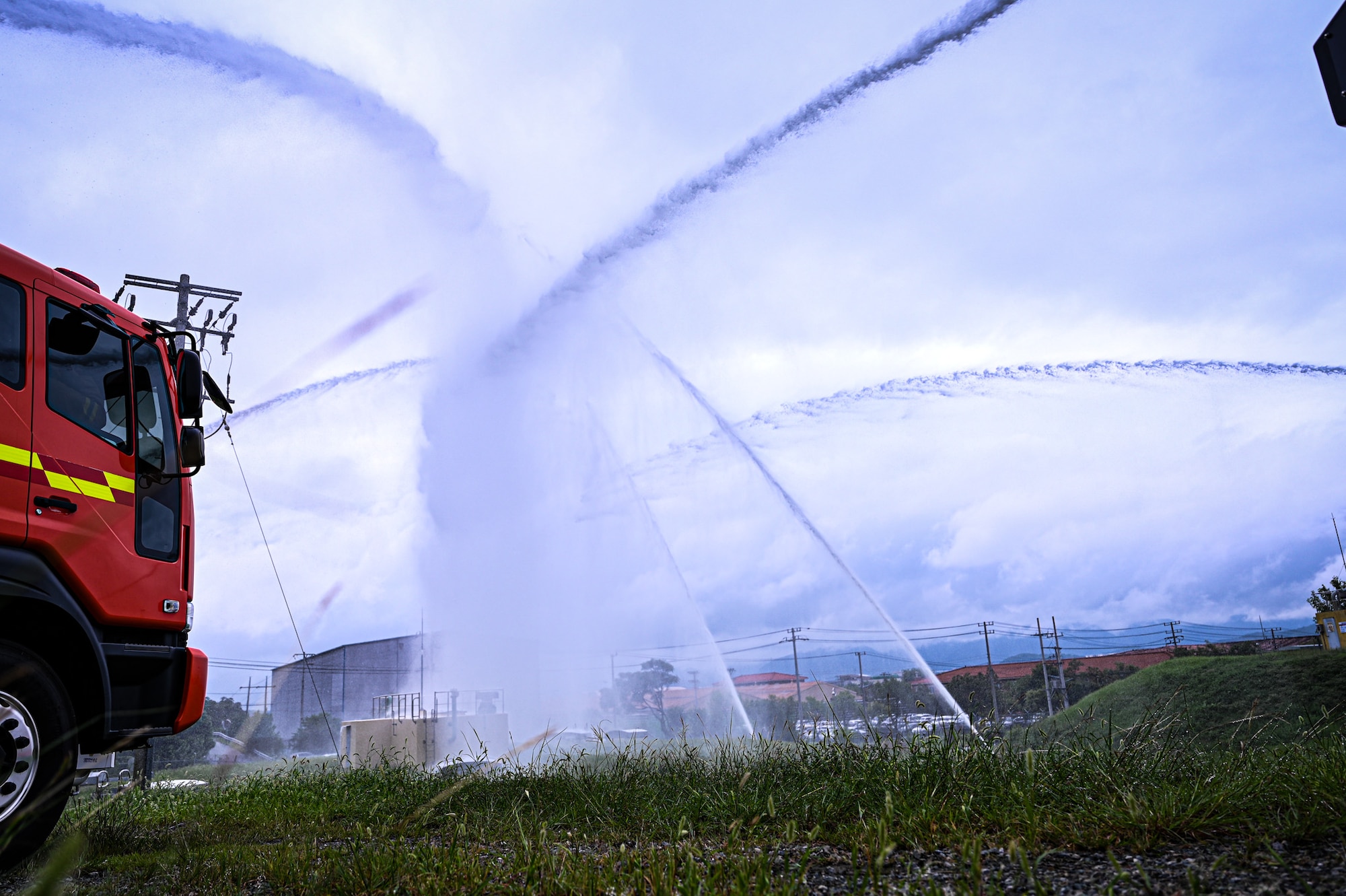 Fire trucks from the U.S. Air Force 11th Combat Air Base Squadron and the Republic of Korea air force launch water from deck guns during a simulated fire response at Daegu Air Base, Republic of Korea, Sept. 10, 2025.