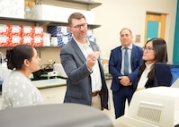 JOINT BASE SAN ANTONIO-FORT SAM HOUSTON (Dec. 8, 2025) Dr. Jeremy Pamplin, (center) program manager, Biological Technologies Office, Defense Advanced Research Projects Agency (DARPA), examines the method by which research scientists at Naval Medical Research Unit (NAMRU) San Antonio assess a wide range of inflammatory biomarkers in biological samples in support of DARPA’s Fieldable Solutions for Hemorrhage with bio-Artificial Resuscitation Products (FSHARP) program at the Battlefield Health & Trauma Research Institute. NAMRU San Antonio serves as the Independent Validation & Verification partner for the FSHARP program to perform laboratory testing for safety and efficacy. The FSHARP program works to develop a deployable, shelf-stable, universal whole blood substitute as a hemorrhage countermeasure to sustain injured warfighters in austere, pre-hospital settings. NAMRU San Antonio, part of Navy Medicine Research & Development, works alongside research partners in the civilian sphere, academia, industry, and other government agencies to drive support of the Department of War’s objectives for a lethal fighting force and ensures U.S. service members have access to the latest scientific advances. NAMRU San Antonio conducts gap-driven combat casualty care, craniofacial, and directed energy research in support of Navy, Marine Corps and joint U.S. warfighter health readiness and lethality while engaged in routine and expeditionary operations. (U.S. Navy photo by Burrell Parmer/Released)