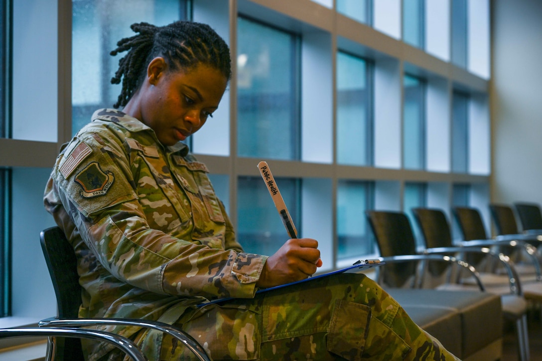 A service member fills out medical forms