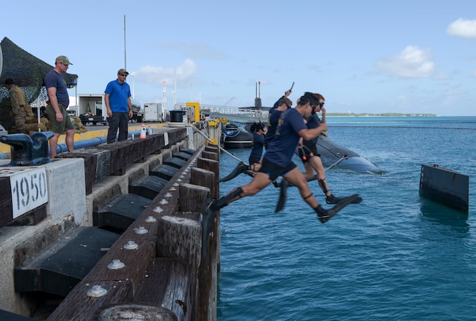 Sailors assigned to submarine tender USS Emory S. Land (AS 39) perform a front step water entry for an Anti-terrorism Force Protection Security Swim during the Ohio-class ballistic-missile submarine USS West Virginia (SSBN-736) port visit at U.S. Navy Support Facility (NSF) Diego Garcia.
