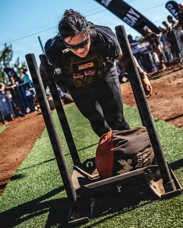 woman wearing workout gear pushes a cart.