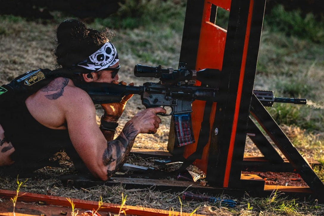 woman wearing workout gear shoots a rifle.