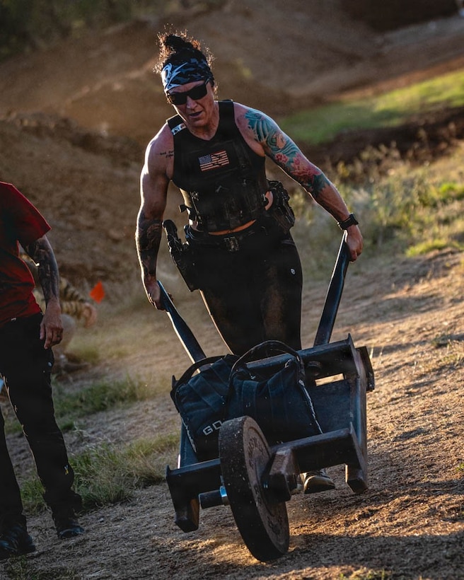 woman wearing workout gear pushes a cart.