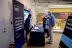 Javier Jimenez (Left), U.S. Naval Research Laboratory research chemist, answers questions to attendees during Military Medical Innovation Family Program at the National Museum of Health and Medicine, in Silver Spring, MD, April 26, 2025. Jimenez worked on Designing thermoreversible gels for extended release of mosquito repellent. (U.S. Navy photo by Jonathan Steffen-Arnold)