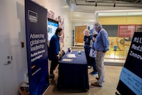 Javier Jimenez (Left), U.S. Naval Research Laboratory research chemist, answers questions to attendees during Military Medical Innovation Family Program at the National Museum of Health and Medicine, in Silver Spring, MD, April 26, 2025. Jimenez worked on Designing thermoreversible gels for extended release of mosquito repellent. (U.S. Navy photo by Jonathan Steffen-Arnold)
