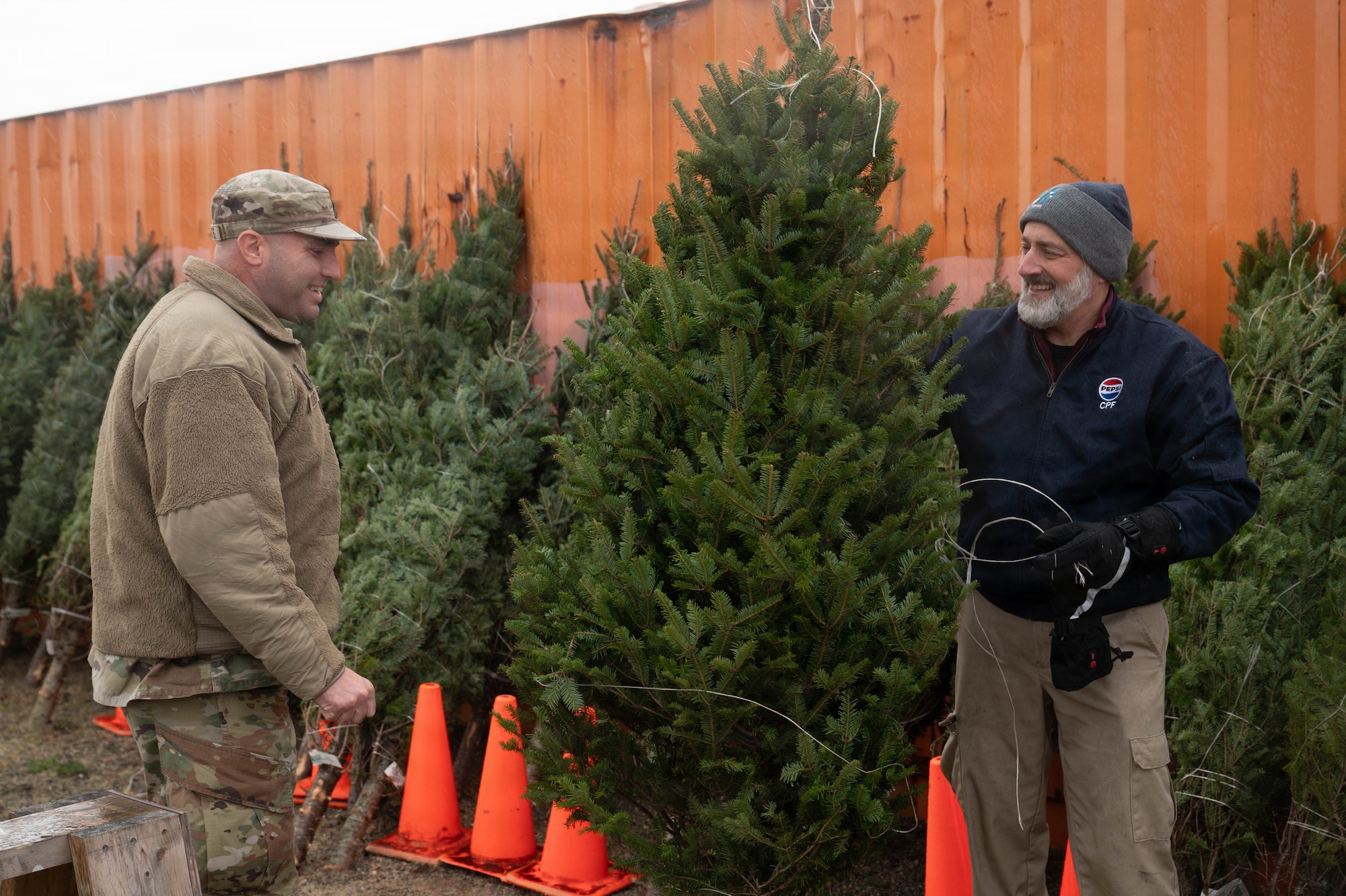 Firmani holds tree for Airman.