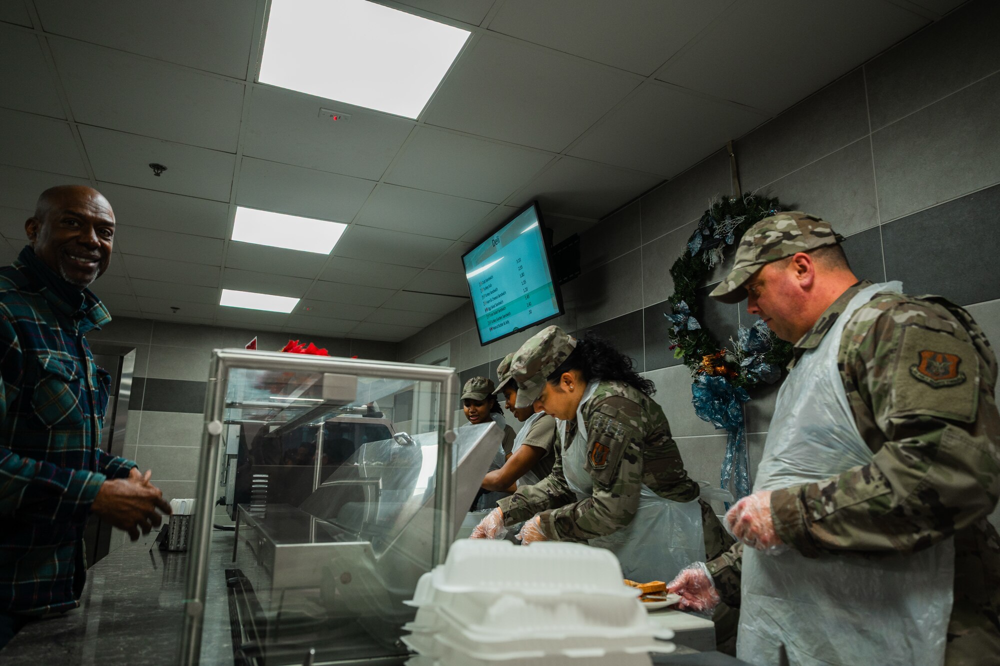 Demonstrating the Air Force core values of Service Before Self and Excellence In All We Do, Airmen of the 459th Air Refueling Wing received a morale-boosting Holiday meal during the December UTA weekend, served by members of the Wing's leadership. The Wing Commander Col. Michael Masuda and Wing Command Chief Chief Master Sgt Anthony Leavitt reinforced their commitment to the Wing's Airmen and Mission by donning aprons and personally taking lead on serving the lunchtime meal, further solidifying unit cohesion and reinforcing the importance of teamwork and selfless service within the 459th. (U.S. Air Force photo by Senior Airman Alexcia Givens)