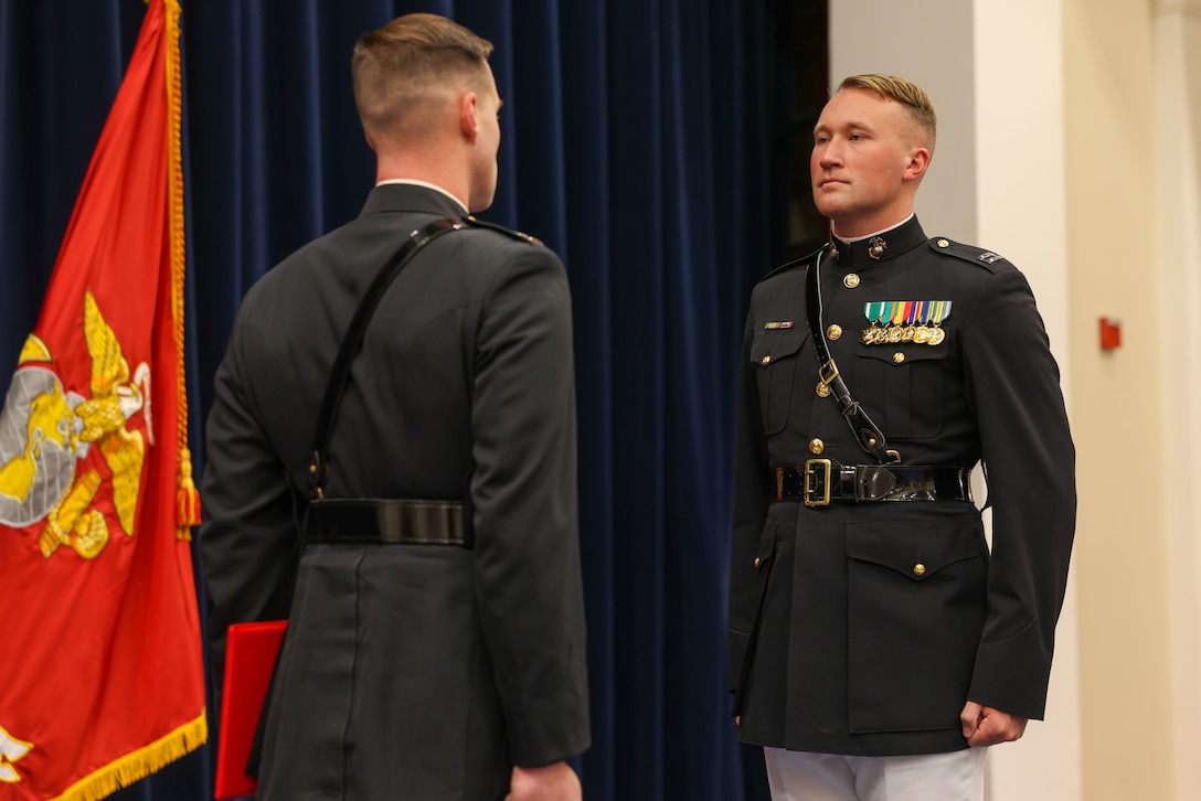 U.S. Marine Corps Capt. Jonathan Kirby, incoming Silent Drill Platoon commander, stands at attention during the Silent Drill Platoon change of command ceremony at Marine Barracks Washington, D.C., Nov. 17, 2025. Kirby will be taking command as the platoon prepares for America's 250 and events throughout 2026. The ceremony highlighted the platoon’s longstanding tradition of precision, discipline, and excellence. (U.S. Marine Corps photo by Cpl. Christopher Prelle)