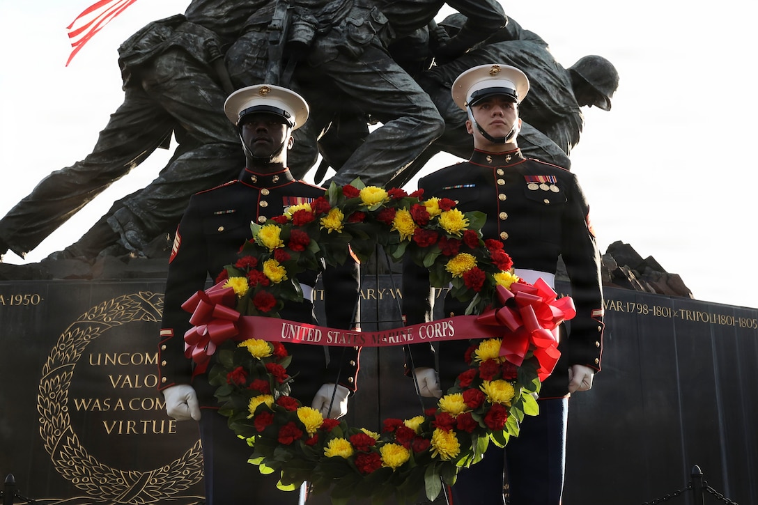 U.S. Marine Corps Sgt. Joshua Williams, left, and Cpl. Kent Place, both with the U.S. Marine Corps Body Bearers, Bravo Company, Marine Barracks Washington, stand at attention before the playing of “Taps” after a wreath is laid at the Marine Corps War Memorial in Arlington, Va., Nov. 7, 2025. The ceremony honored the Marines who gave their lives during the Battle of Iwo Jima. As the Marine Corps approaches its 250th birthday, Marines continue to pay tribute to the valor and sacrifice that define their legacy. (U.S. Marine Corps photo by Lance Cpl. Brynn L. Bouchard)