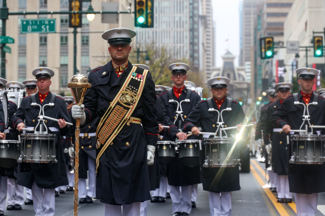 U.S. Marine Corps Master Sgt. David Cox, assistant drum major, "The Commandant's Own", United States Marine Drum & Bugle Corps, marches with the band during the Navy and Marine Corps "Homecoming 250" Parade in Philadelphia, Pa., Oct. 13, 2025.  The event honors 250 years of Marine Corps legacy, tradition, and service by giving Philadelphia residents and visitors the opportunity to connect with Marines and Sailors, learn about the Corps’ values of honor, courage, and commitment, and experience community engagement events, static displays and performances from the Special Purpose Marine Air-Ground Task Force 250. (U.S. Marine Corps photo by Cpl. Christopher Prelle)