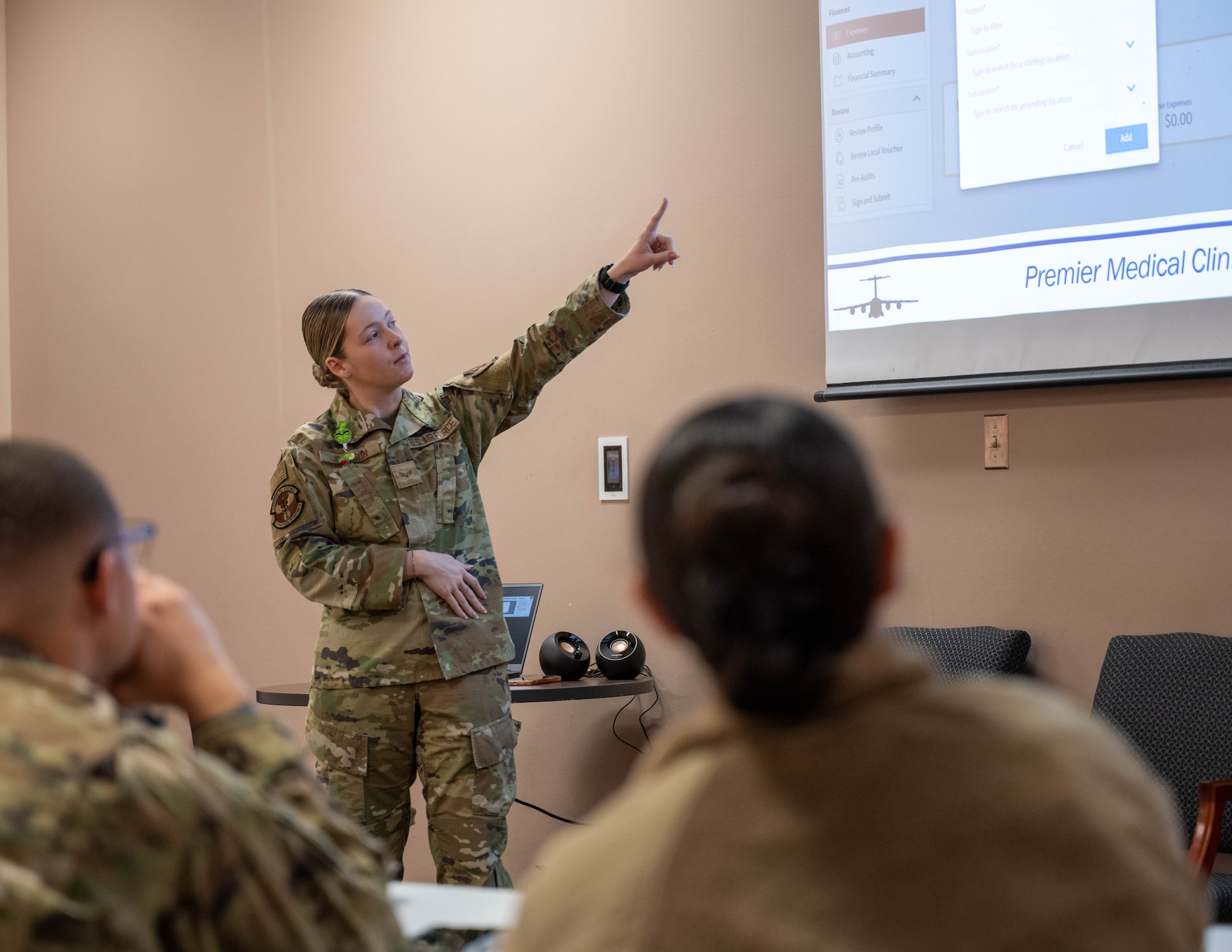U.S. Air Force Senior Airman Natalia Johnson, 97th Healthcare Operations Squadron referral management supervisor, presents “Travel Reimbursement for Medical Appointments” at Altus Air Force Base, Oklahoma, Dec. 9, 2025. This presentation was one of 23 seminars produced by the 97th Air Mobility Wing 10 Days of Professional Development. (U.S. Air Force photo by Airman 1st Class Emma Wright)