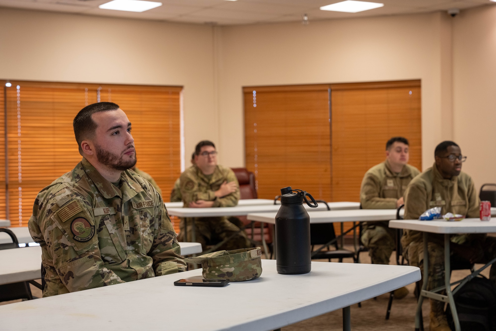 Attendees of the 97th Air Mobility Wing (AMW) 10 Days of Professional Development focus on the facilitator at Altus Air Force Base, Oklahoma, Dec. 10, 2025. The goal of this program was to leverage collective knowledge and experience within the 97th AMW to foster a stronger, wiser, and more capable force. (U.S. Air Force photo by Airman 1st Class Emma Wright)