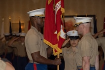 U.S. Marine Corps Maj. Cory Tribble, left, incoming commanding officer of Recruiting Station Chicago receives the colors from Maj. Branden Koonce, right, during a change of command ceremony in Rosemont, Illinois, July 7, 2025. Recruiting Station Chicago held the change of command ceremony to formally transfer command from Maj. Brandon D. Koonce to Maj. Cory D. Tribble, symbolizing the shift in leadership, authority, and responsibility for the station. (U.S. Marine Corps photo by Sgt. Dalton J. Payne)