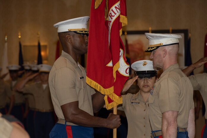 U.S. Marine Corps Maj. Cory Tribble, left, incoming commanding officer of Recruiting Station Chicago receives the colors from Maj. Branden Koonce, right, during a change of command ceremony in Rosemont, Illinois, July 7, 2025. Recruiting Station Chicago held the change of command ceremony to formally transfer command from Maj. Brandon D. Koonce to Maj. Cory D. Tribble, symbolizing the shift in leadership, authority, and responsibility for the station. (U.S. Marine Corps photo by Sgt. Dalton J. Payne)