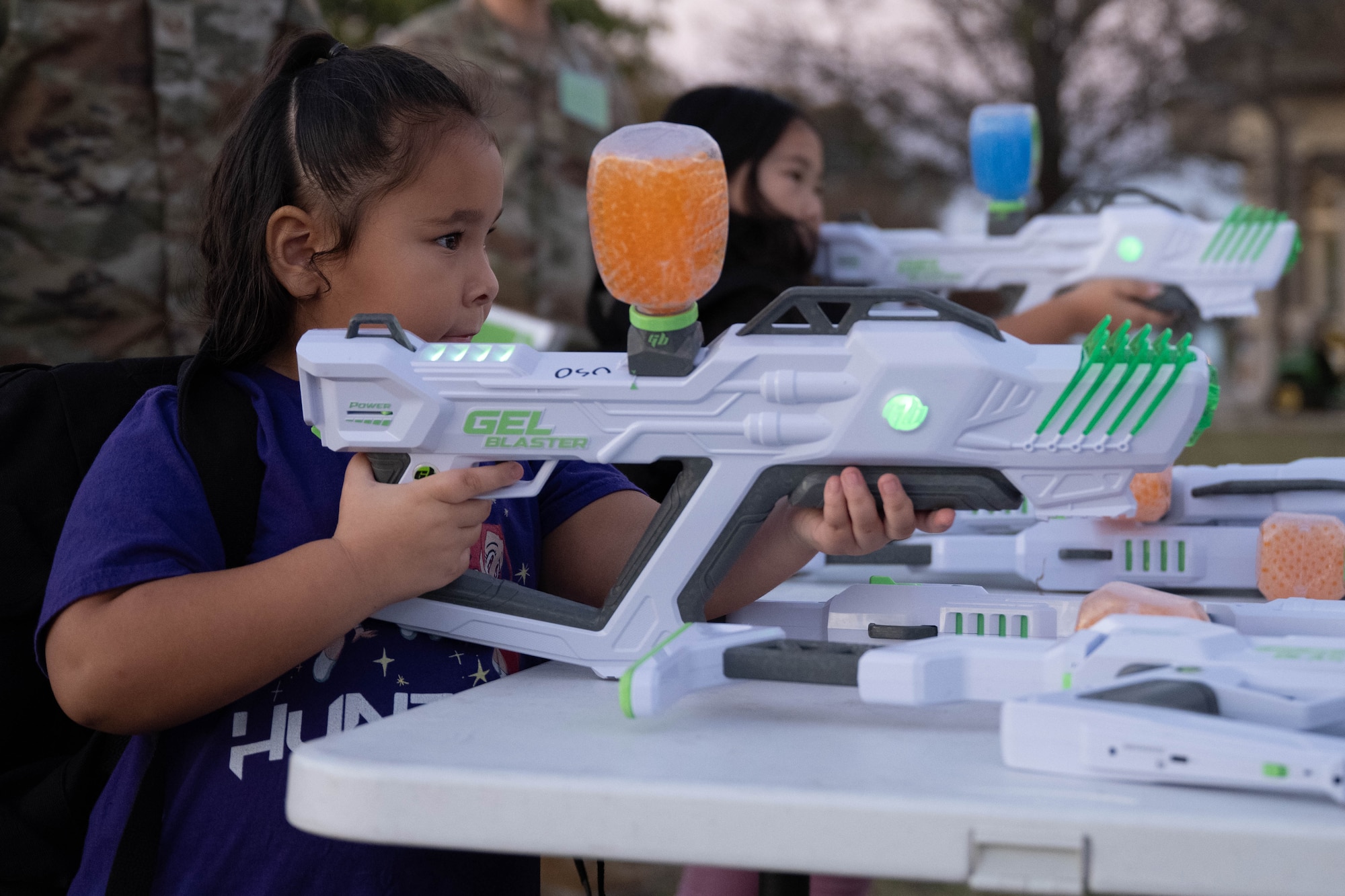 Junior Deployment participants prepare to fire gel blasters at Laughlin Air Force Base, Texas, Nov. 21, 2025. Participants simulated a weapons qualification course during a Junior Deployment event. (U.S. Air Force photo by Airman 1st Class Darryl Keith)