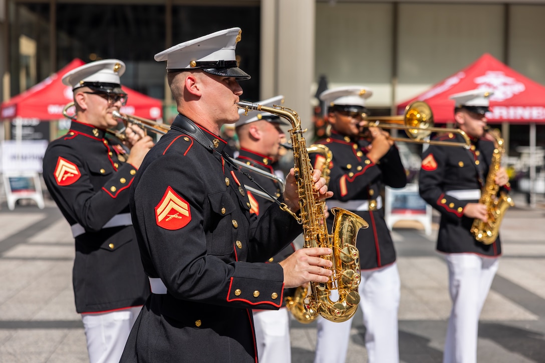 U.S. Marine Corps Band Quantico performs at a static display at the Magnificent Mile during Marine Week Chicago July 11, 2025. During Marine Week Chicago, Marines with Marine Corps Recruiting Command shared Marine Corps traditions with local high schools in honor of the Corps’ 250th birthday. The Marine Corps is celebrating its 250th birthday with six multi-day Marine Corps community events, called Marine Weeks, in six major cities across the country. Marine Weeks will include activations across each host city featuring aircraft, equipment, recruiting opportunities, and public engagements. (U.S. Marine Corps photo by Cpl. Maxwell Cook)