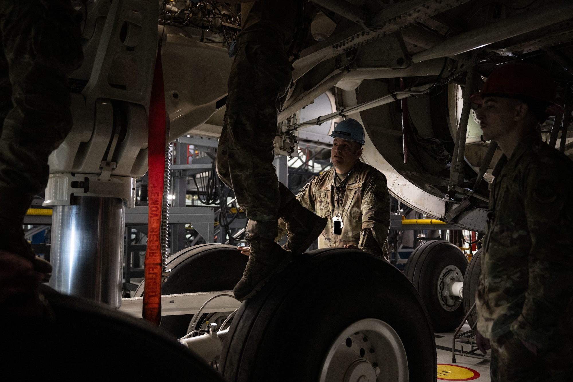 U.S. Air Force Senior Master Sgt. Adam Crothers, 436th Maintenance Squadron maintenance superintendent, checks in with Airmen as they work on a C-5M Super Galaxy in the 436th MXS Isochronal Inspection Dock at Dover Air Force Base, Delaware, Oct. 15, 2025. As superintendent, Crothers regularly visits the Airmen under his care, checking in with them and ensuring they have the safety gear and necessary tools to complete their work. (U.S. Air Force photo by Airman 1st Class Liberty Kuhn)
