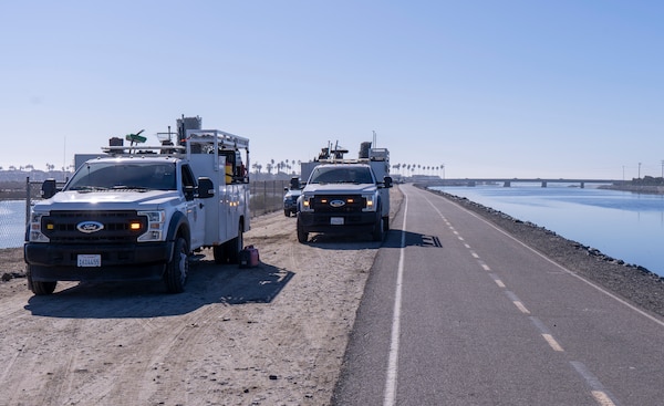 Orange County Operations and Maintenance vehicles stage along the pathway at the lower Santa Ana River Marsh during a multi-agency cleanup operation Dec. 10 in Newport Beach, California. More than 60 personnel from federal, county and city agencies supported the half-day effort.