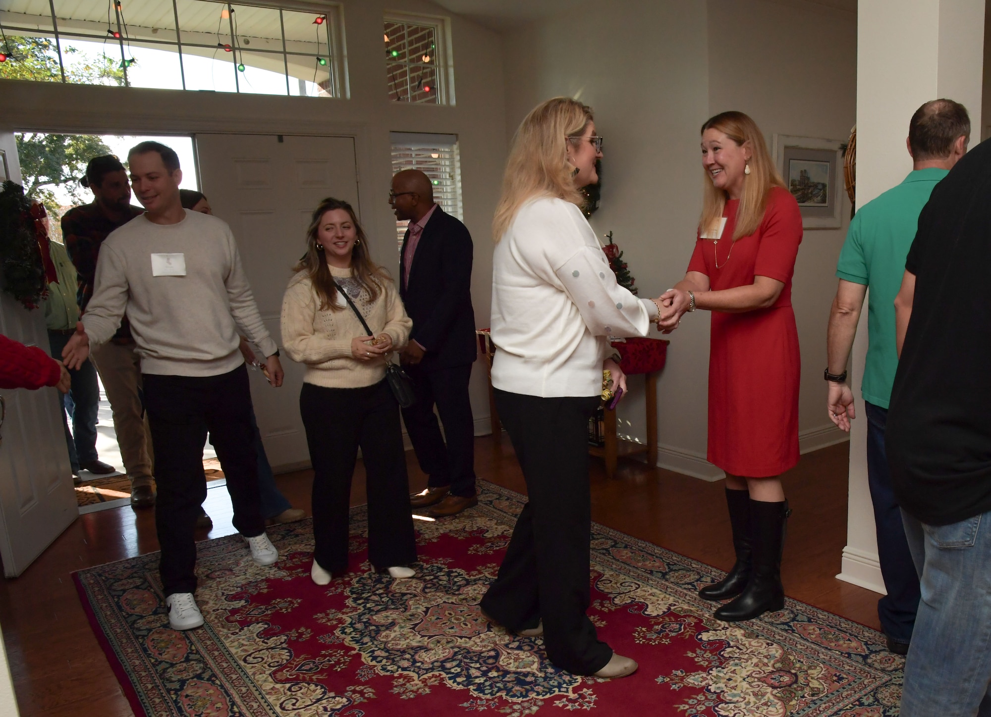 People are greeted as they enter a house.