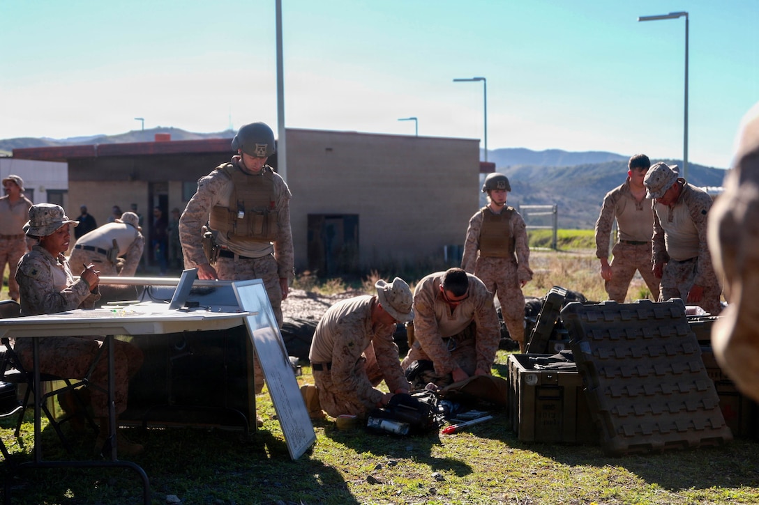 A U.S. Navy Hospital Corpsman with 1st Battalion, 5th Marine Regiment, 1st Marine Division, uses a battlefield assisted trauma documentation kit to document care during a simulated mass casualty exercise during Exercise Steel Knight 25 at Marine Corps Base Camp Pendleton, California, Dec. 6, 2025. Steel Knight is an annual exercise that strengthens the Navy-Marine Corps team's ability to respond forward, integrate across domains, and sustain Marine Air-Ground Task Force readiness. (U.S. Marine Corps photo by Cpl. Michael Bartman)
