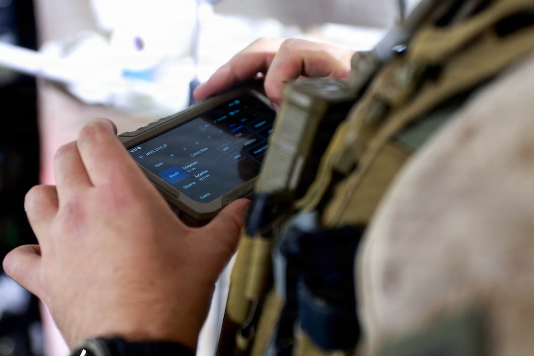 A U.S. Navy Hospital Corpsman with 1st Battalion, 5th Marine Regiment, 1st Marine Division, uses a battlefield assisted trauma documentation kit to document care during a simulated mass casualty exercise during Exercise Steel Knight 25 at Marine Corps Base Camp Pendleton, California, Dec. 6, 2025. Steel Knight is an annual exercise that strengthens the Navy-Marine Corps team's ability to respond forward, integrate across domains, and sustain Marine Air-Ground Task Force readiness. (U.S. Marine Corps photo by Cpl. Michael Bartman)