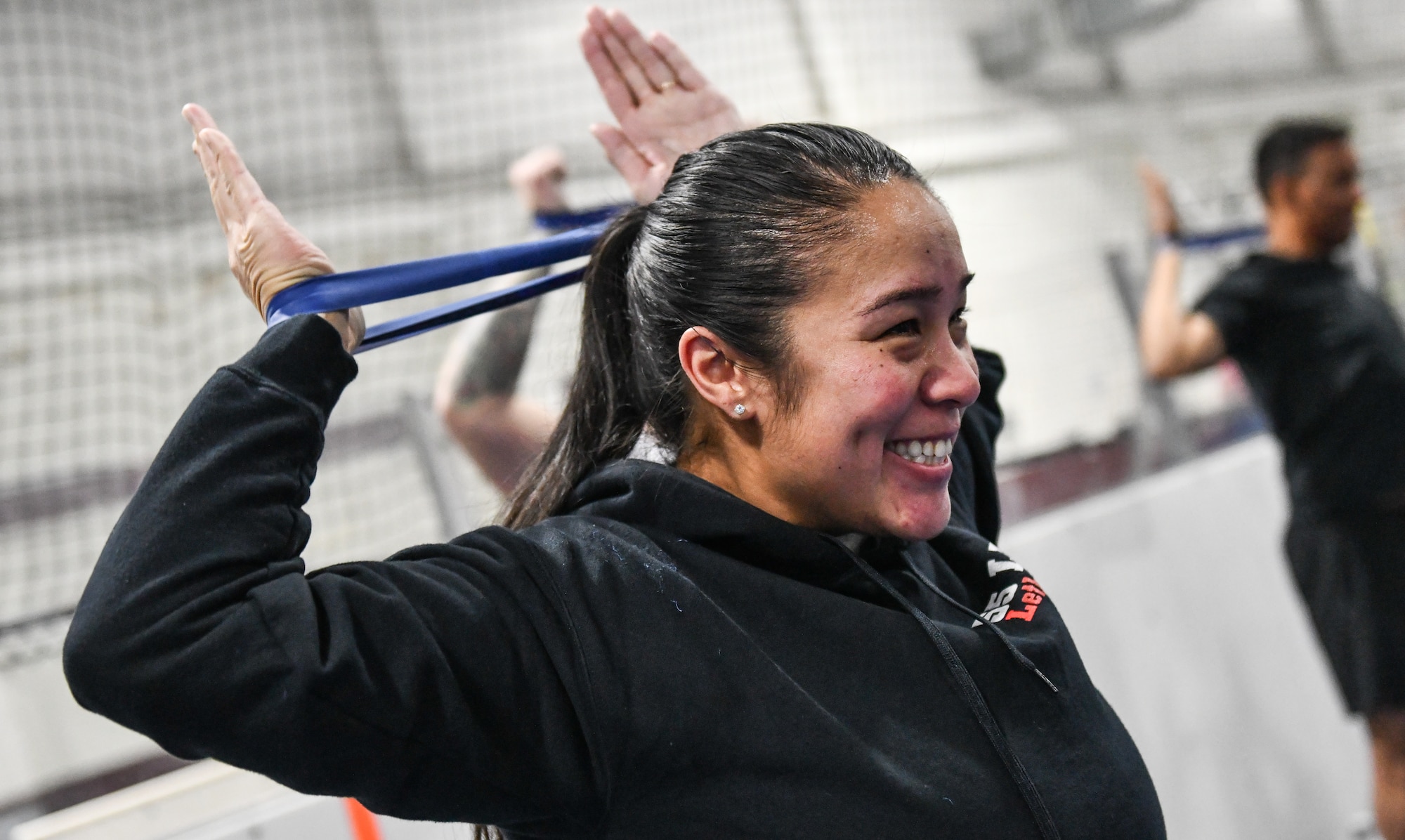 Chief Master Sgt. Erica Davis, 55th Logistics Readiness Squadron senior enlisted leader, performs arm stretches at the Offutt Field House, December 12, 2025. (U.S. Air Force photo by Chad Watkins)