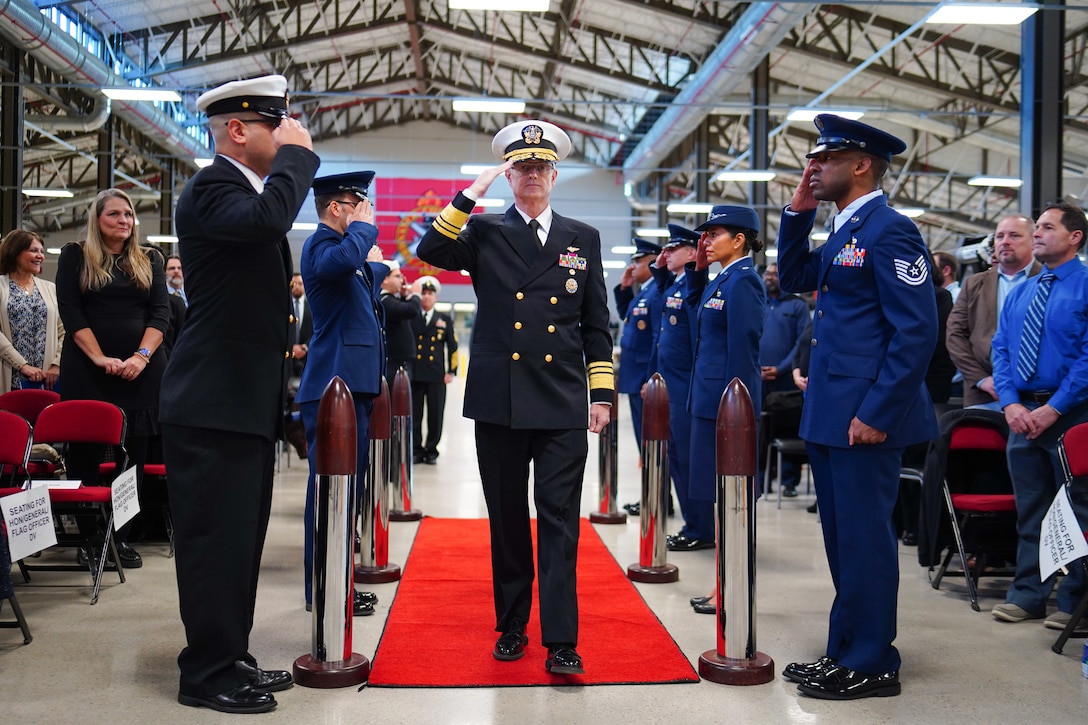 DCMA's new director salutes as he enters the agency's change of leadership ceremony.